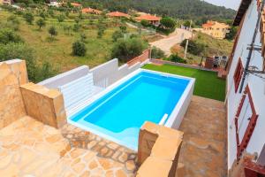 a swimming pool in a villa with a view at Can Prats in Ríudecañas