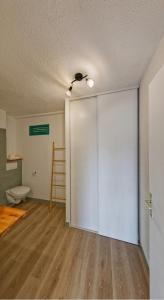 an empty room with a sliding door and a toilet at Lilibellule - Apt 107 situé dans une résidence touristique in Les Trois-Îlets