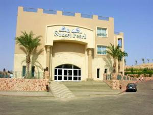 a building with a car parked in front of it at Sunset pearl sahl hasheesh in Hurghada