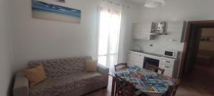 a living room with a couch and a table at Appartamento Valentina in San Vito lo Capo