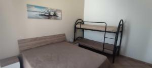 a bedroom with two bunk beds and a picture on the wall at Appartamento Valentina in San Vito lo Capo +33 photos