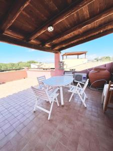 a table and two chairs on a patio at Praialonga - Attico con terrazzo in Le Castella