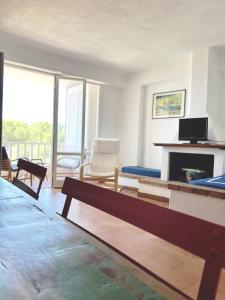 a living room with a couch and a fireplace at Praialonga - Attico con terrazzo in Le Castella
