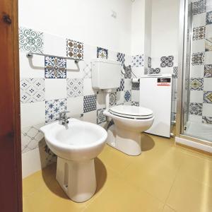 a bathroom with a toilet and a sink at Praialonga - Attico con terrazzo in Le Castella