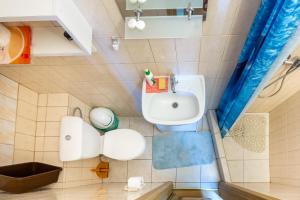 a bathroom with a sink and a toilet at Pokoje gościnne Panda in Karwia +43 photos