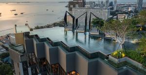 a building with a pool in the middle of a city at Condo Edge Central in Pattaya