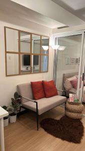 - un salon avec un canapé et un lit dans l'établissement Lovely Studio Unit in Celandine, à Manille
