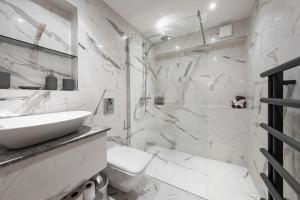 uma casa de banho branca com um lavatório e um chuveiro em Shockerwick Cottage em Bath