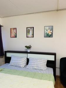 a bedroom with a bed with two pillows on it at Condo poppular T8 fl14 in Thung Si Kan
