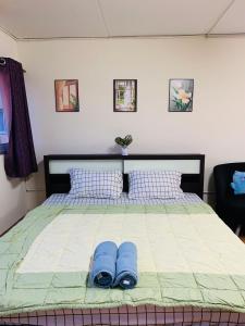 a bed with two pairs of blue slippers on it at Condo poppular T8 fl14 in Thung Si Kan