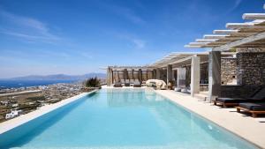 a swimming pool with a view of the ocean at Home of the Gecko - Mykonos Town in Megali Ammos