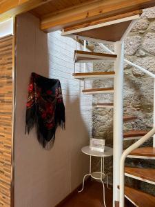 a staircase in a house with a mask on the wall at CASA DA QUELHA in Soajo