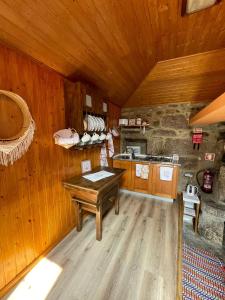 a kitchen with wooden walls and a wooden floor at CASA DA QUELHA in Soajo +24 photos