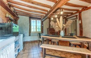 a kitchen and dining room with a table and chairs at Pet Friendly Home In Touffreville With Kitchen in Touffreville