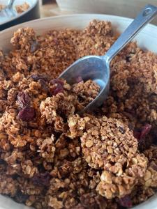 a bowl of granola with a spoon in it at LOGIS HOTEL - La Petite Rade in Le Havre