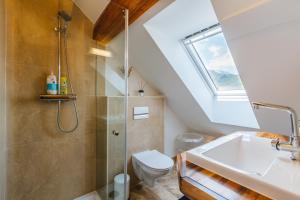 a bathroom with a shower and a toilet and a sink at Pr'Jernejc Agroturism in Lesce