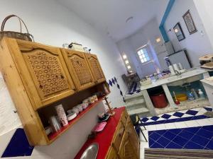 a kitchen with a sink and a wooden cabinet at EL Fouly Villa with beach front فيلا لمة العيله الفولي - سيدي كرير in Abû Zeira