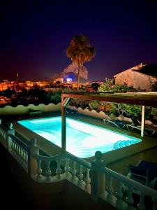 a swimming pool on a balcony at night at Villa Bon Dia in Calpe