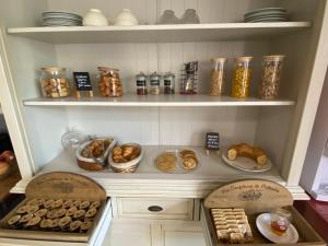 a pantry with shelves filled with different types of food at Contact Hotel LE SUD Montpellier Aéroport Parc Expo Arena in Mauguio