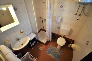 a bathroom with a sink and a toilet and a shower at Apartments Mica in Lopar +28 photos