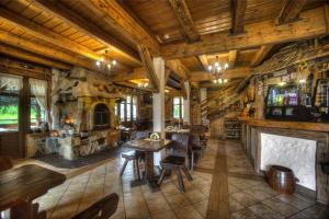 a large room with wooden ceilings and tables and chairs at Dworek Sanocki in Sanok