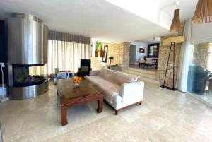 a living room with a couch and a table at Ibiza 7th Heaven Villa in Sant Josep