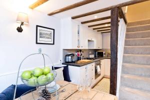 a kitchen with a bowl of apples on a table at Applehoe Cottage in Bakewell