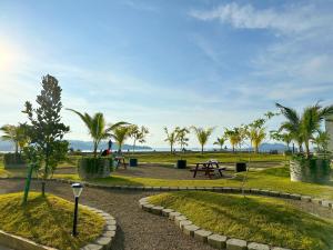 a park with palm trees and a picnic table at Sea Lavie Homestay@Kota Kinabalu (海旅维) in Kota Kinabalu