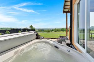 a bath tub in front of a window at Pine Grove Scenic View Unforgettable Love Getaway in Pine Grove