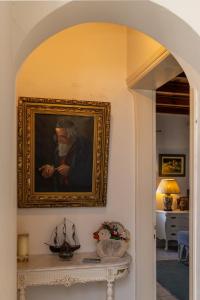 a painting of a man is hanging on a wall at Sophisticated Central House Tinos in Tinos
