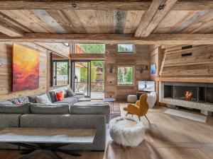 a living room with a couch and a fireplace at Chalet Val-d'Isère, 7 pièces, 14 personnes - FR-1-567-38 in Val-d'Isère