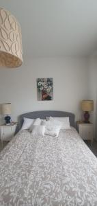 a bed in a bedroom with two tables and two lamps at Residence Eucalyptus Suite 2 casa indipendente in Sanremo