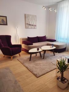 a living room with a couch and two tables at Kalemegdan Park Residence - new luxury apartment in Belgrade