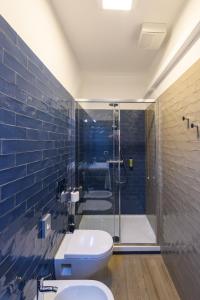 a bathroom with a toilet and a glass shower at Hotel & Apartments Sasso in Diano Marina