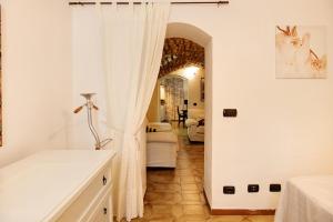a room with a bed and a white curtain at Casafiò Grotta in Cassinasco