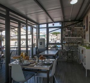 a dining room with a table with food on it at La Terrazza ai Miracoli in Naples