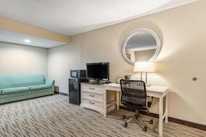 a room with a desk with a computer and a chair at SureStay Hotel by Best Western Tupelo North in Tupelo