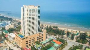 an aerial view of a tall building next to the beach at Căn hộ nghỉ dưỡng bên bờ biển in Dong Quan