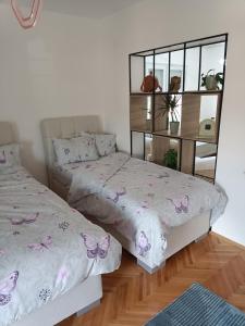 a bedroom with two beds with butterflies on them at Big Apartment Veles in Veles +15 photos