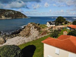 an aerial view of a house and the ocean at Villa Roxemar en Costa da Morte in A Coruña
