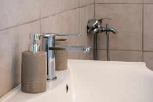a bathroom sink with a faucet on top of it at Nota's Home in Flogita +23 photos