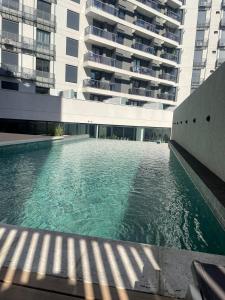 a swimming pool in front of a large building at Betania Plaza in Cordoba