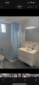 a bathroom with a sink and a toilet and a mirror at By the sea dome in Maronia +16 photos