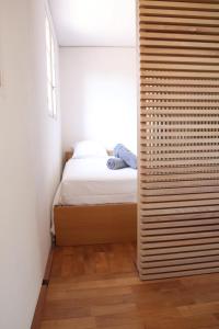 a small bedroom with a bed and a window at T2 dans une résidence au coeur du Brusc in Six-Fours-les-Plages