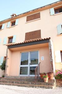 a building with windows and potted plants in front of it at T2 dans une résidence au coeur du Brusc in Six-Fours-les-Plages