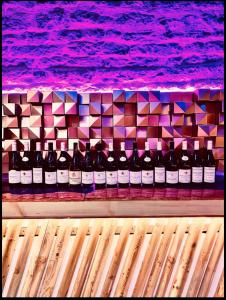 a bunch of bottles of wine on a shelf at Domaine Les Hauts Prés in Villaines-les-Prévôtes