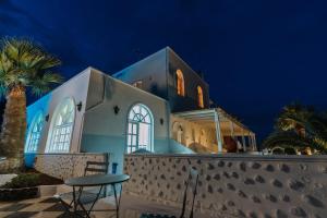 a church with a table in front of it at night at Blue Life Hotel in Emboríon