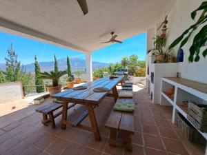 a wooden table on a patio with a view at Casa Amani in Viñuela