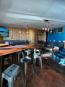a ping pong table and stools in a room at LOGIS HOTEL - La Petite Rade in Le Havre