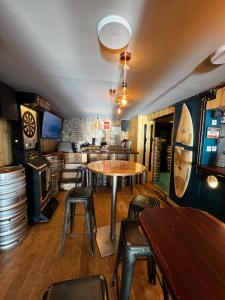 a room with a table and chairs and a bar at LOGIS HOTEL - La Petite Rade in Le Havre